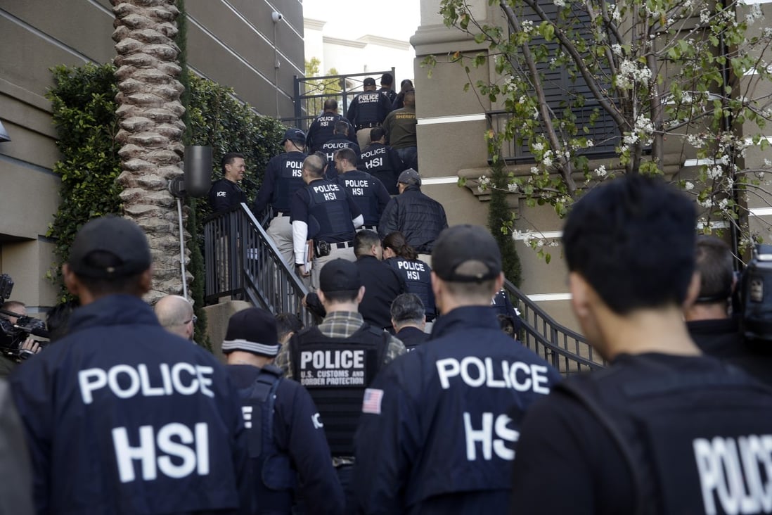 Federal agents enter an upscale flat complex in Irvine, California during a raid in 2015. File photo: AP