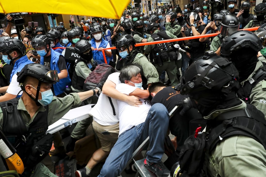 Veteran opposition politician Lee Cheuk-yan is surrounded by riot police during an illegal demonstration against Hong Kong’s new national security law on July 1. Photo: Sam Tsang