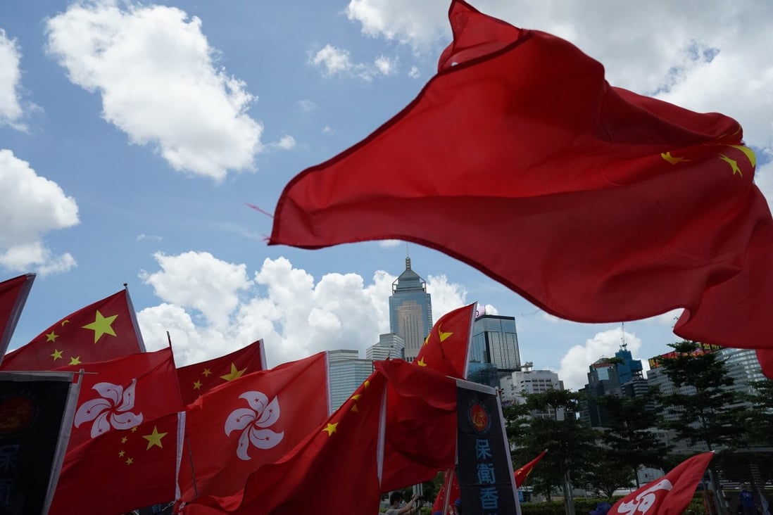Pro-Beijing supporters wave the Hong Kong and national flag to celebrate the passage of the national security law on Tuesday. Photo: Felix Wong