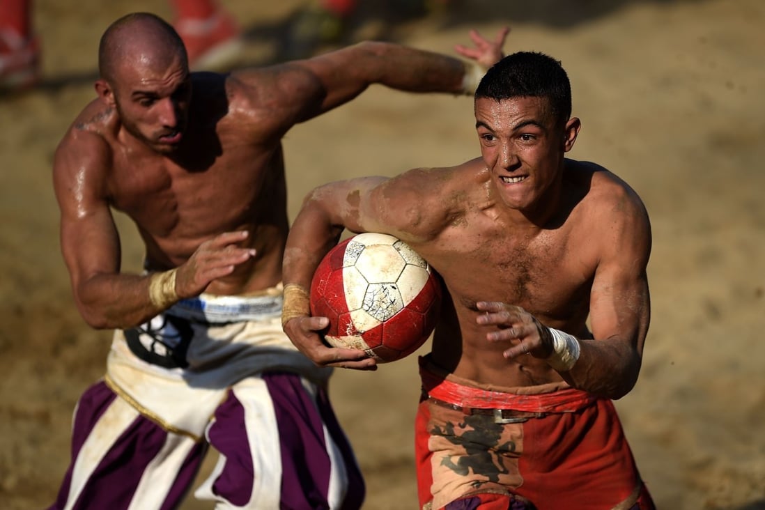 Players compete during the final of the annual calcio storico series in Florence, Italy. Photo: AFP
