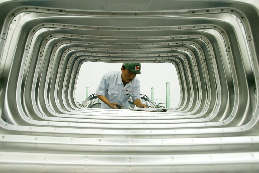 An Indonesian worker assembles rear doors at a Daihatsu plant in Jakarta. Photo: Reuters