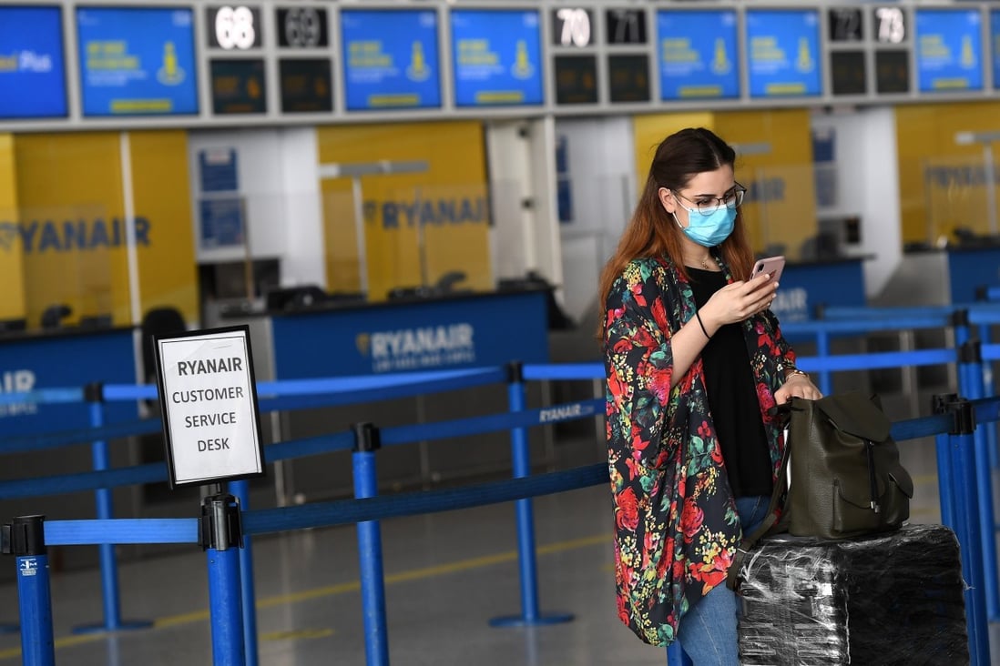 A passenger wearing a face mask is seen at London Stansted Airport on July 1. Photo: EPA