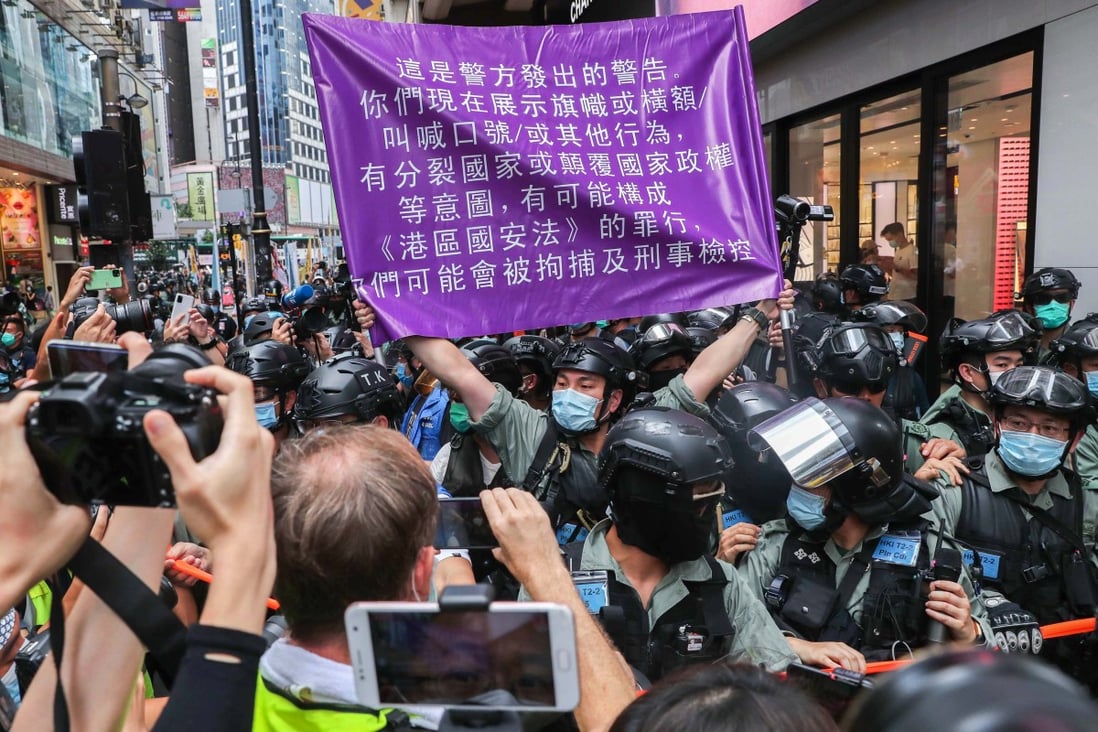 Police brought out for the first time a new, purple flag warning against breaking the national security law. Photo: Sam Tsang