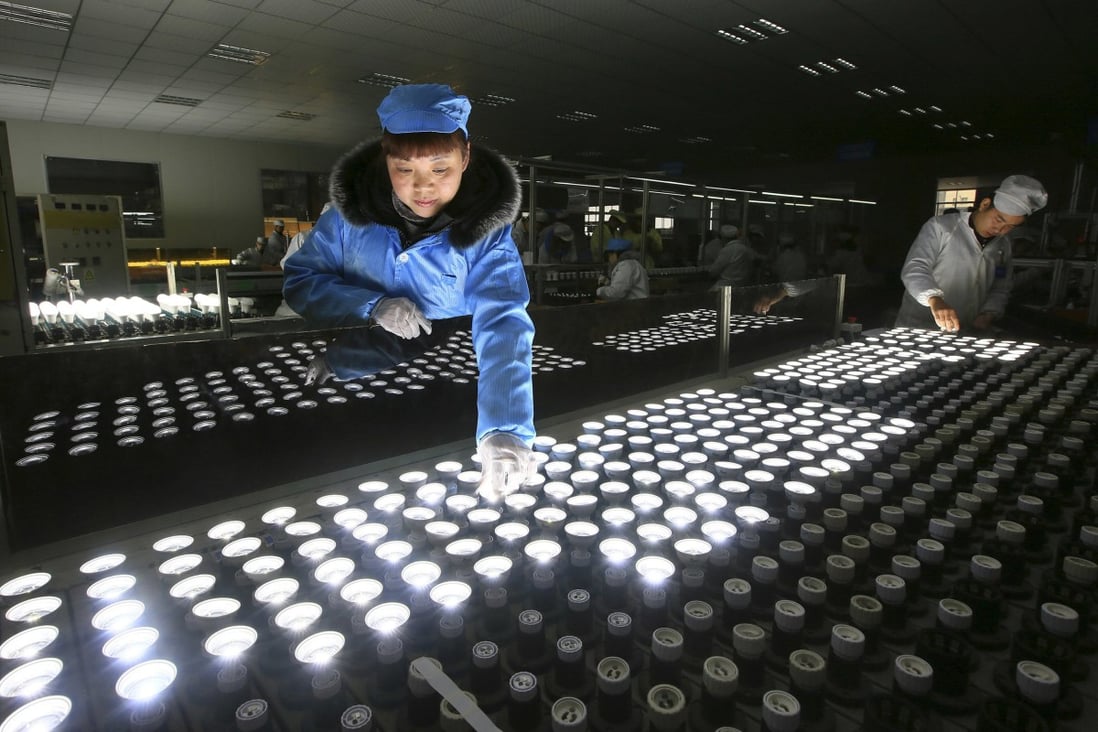 A worker tests LED lights at a factory in Suining city in southwestern China's Sichuan province on February 28, 2017. Photo: Chinatopix via AP