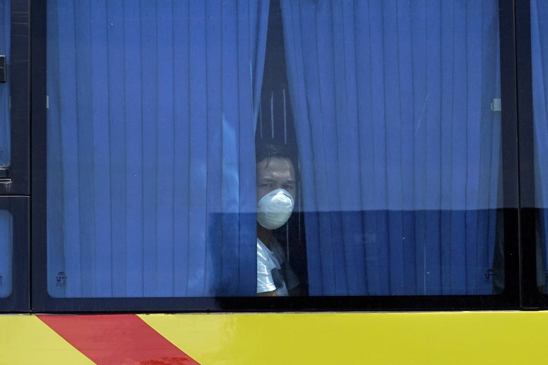 A repatriated overseas Filipino overseas worker looks on from a bus in Cebu City, the Philippines. Photo: EPA