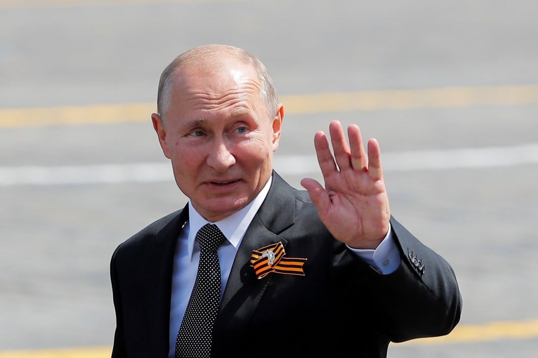 Russian President Vladimir Putin waves as he leaves after the Victory Day Parade in Red Square in Moscow. Photo: Reuters