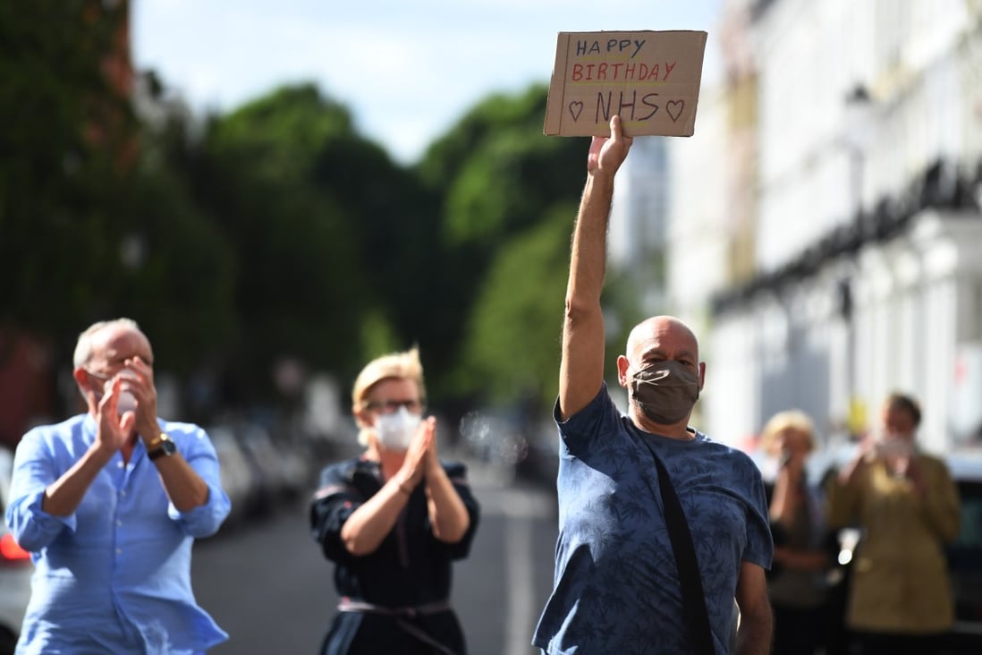 People applaud as they clap for Britain's National Health Service (NHS) outside Chelsea and Westminster hospital in London. Photo: EPA-EFE