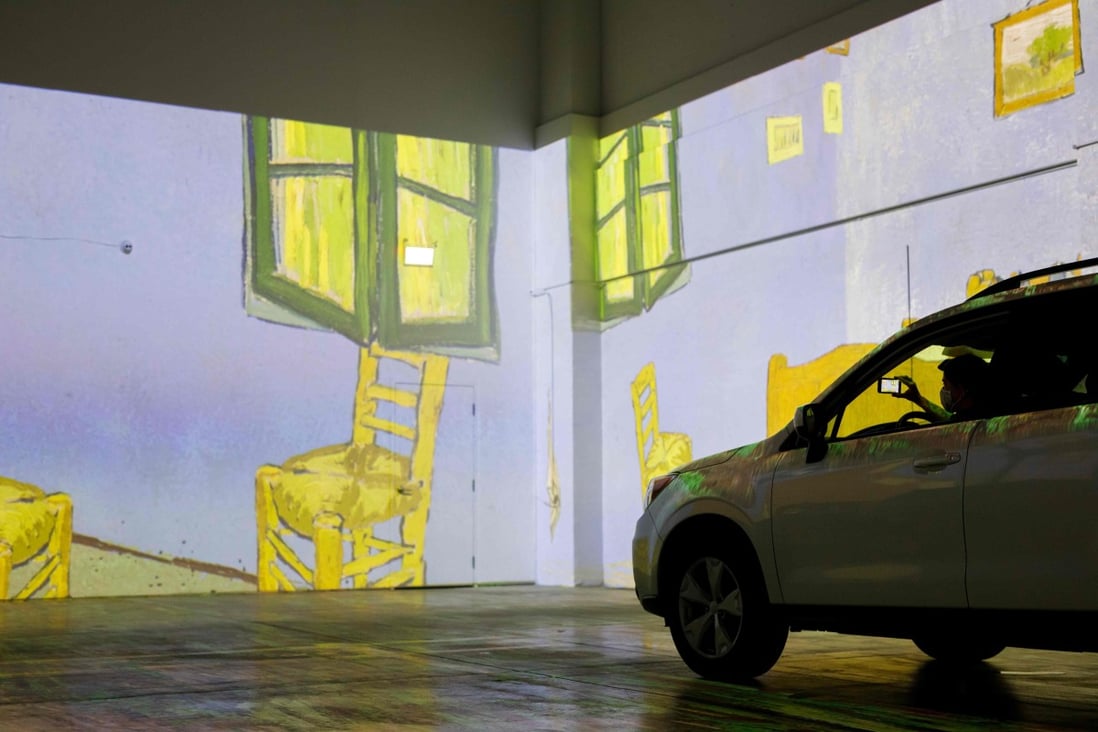 People take photos from their car at the drive-in Vincent van Gogh immersive art show in Toronto, Canada. Photo: Cole Burston/AFP