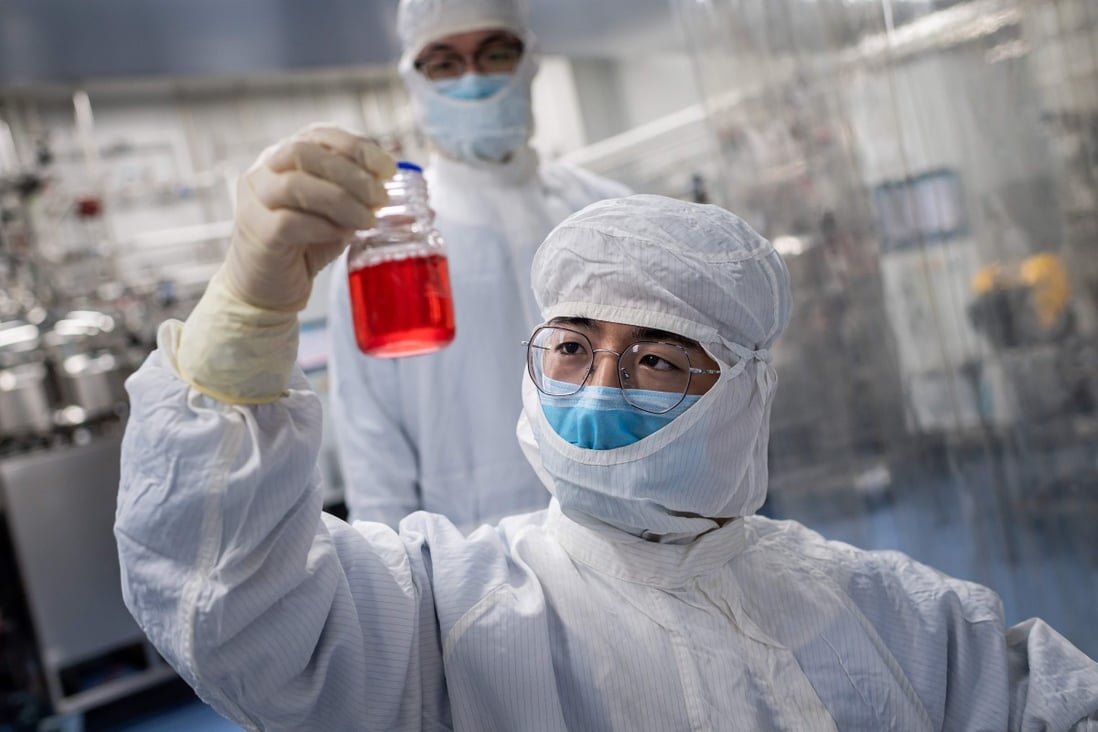 An engineer looks at monkey kidney cells as he conducts a test of an experimental vaccine for the Covid-19 coronavirus at the Sinovac Biotech facilities in Beijing on April 29. Photo: AFP