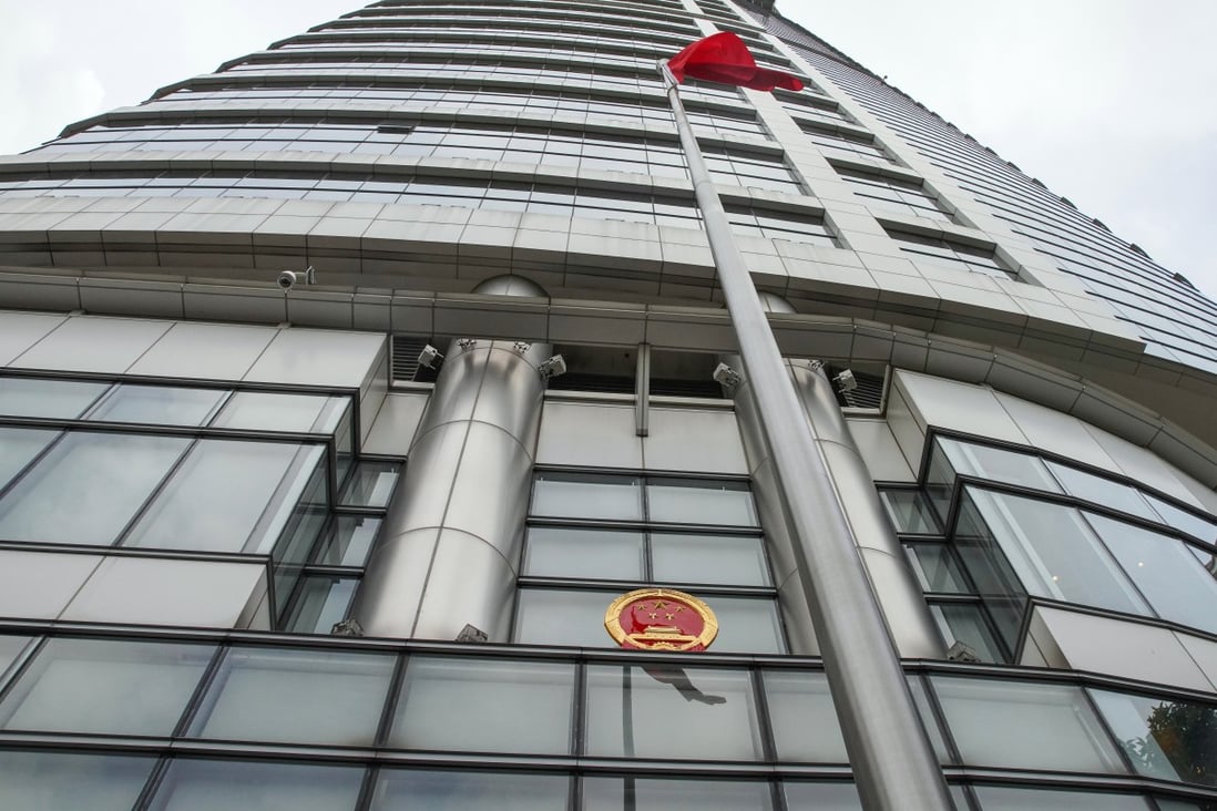The Chinese flag and national emblem outside the temporary base for Hong Kong’s new Office for Safeguarding National Security. Photo: Winson Wong