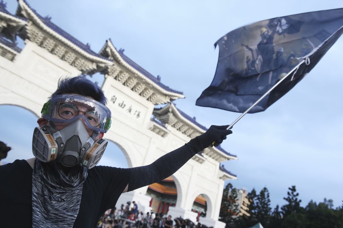 A Hong Kong protester in Taiwan last month marks the first anniversary of a mass rally in the city. Photo: AP