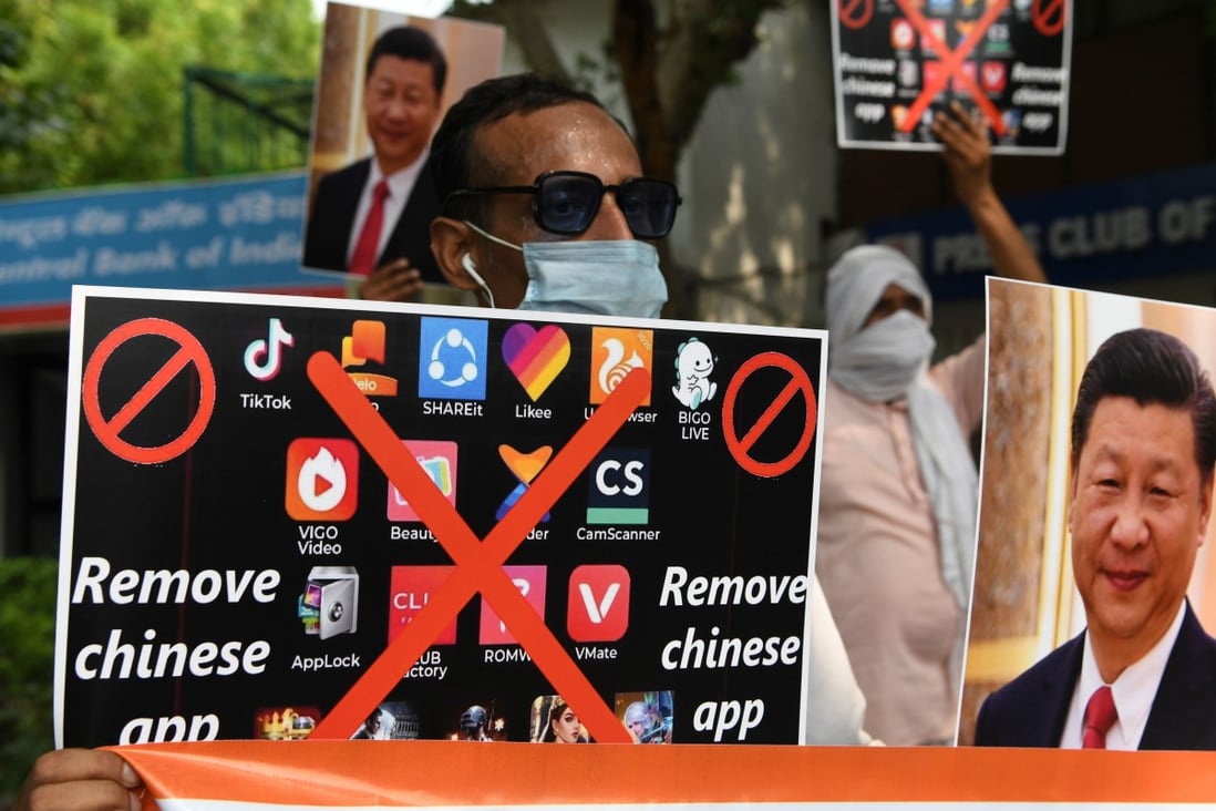 Members of the Working Journalists of India hold placards urging citizens to remove Chinese apps and stop using Chinese products during a protest in New Delhi on June 30. Photo: Photo: Agence France-Presse