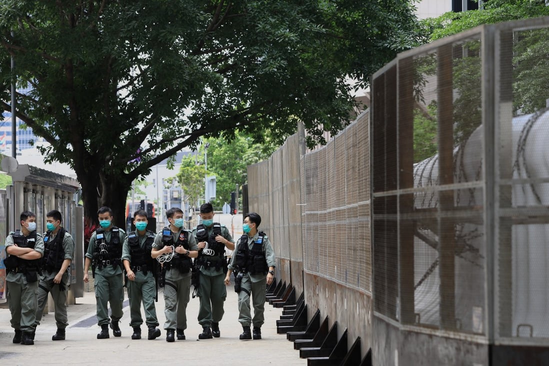 A group of police officers patrol outside government headquarters in Admiralty. Photo: May Tse