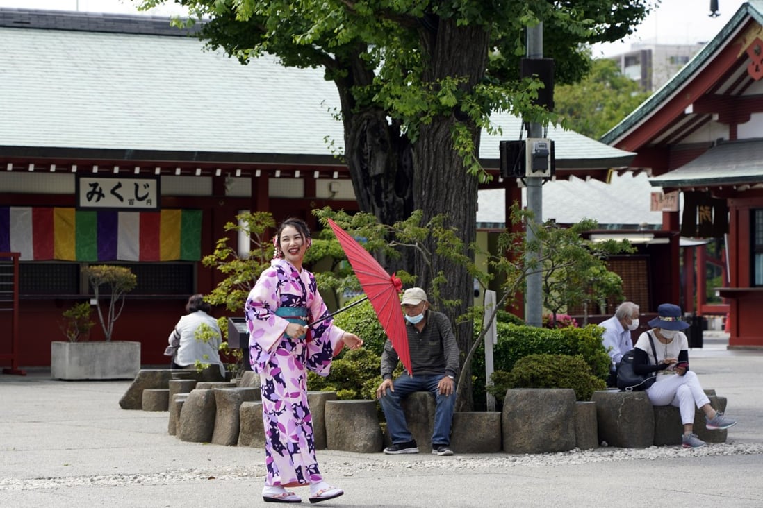 A kimono-clad tourist and others visit the Sensoji temple in the Asakusa district of Tokyo, Japan, on June 24. As tourist arrivals are unlikely to pick up in the short term, capacity in the hospitality sector will remain underutilised for some time. Photo: EPA-EFE