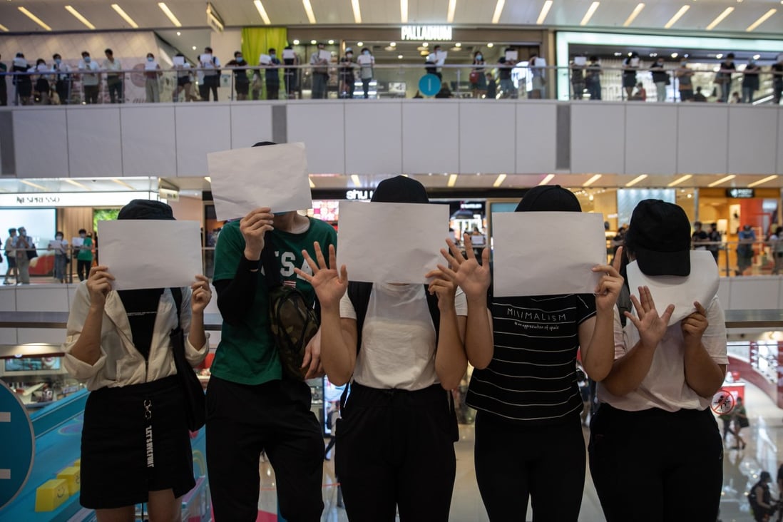 Protesters display sheets of plain white paper during a protest in a shopping mall in Hong Kong on July 6, after the government warned that the use of the slogan, “Liberate Hong Kong, Revolution of Our Times”, risked flouting the new national security law. Photo: EPA-EFE