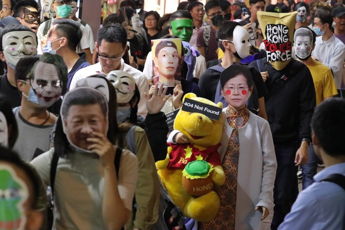 Mask-wearing anti-government protesters march in Causeway Bay on Halloween night. Photo: May Tse