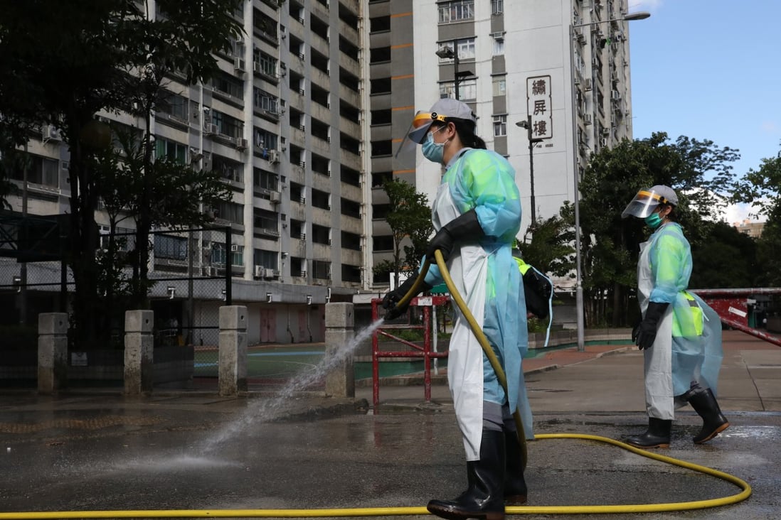 Workers in protective gear disinfect the streets on July 5 in and around Long Ping Estate in Yuen Long, where a 59-year-old man living in one of the flats contracted coronavirus. It was the first locally-transmitted case of Covid-19 since mid-June. Photo: Dickson Lee