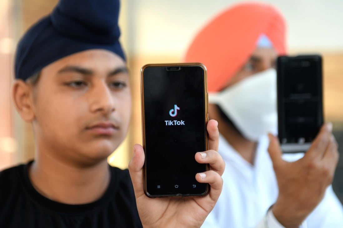 Indian mobile users browse through the Chinese owned video-sharing Tik Tok app on smartphones in Amritsar on June 30, 2020. Photo: AFP