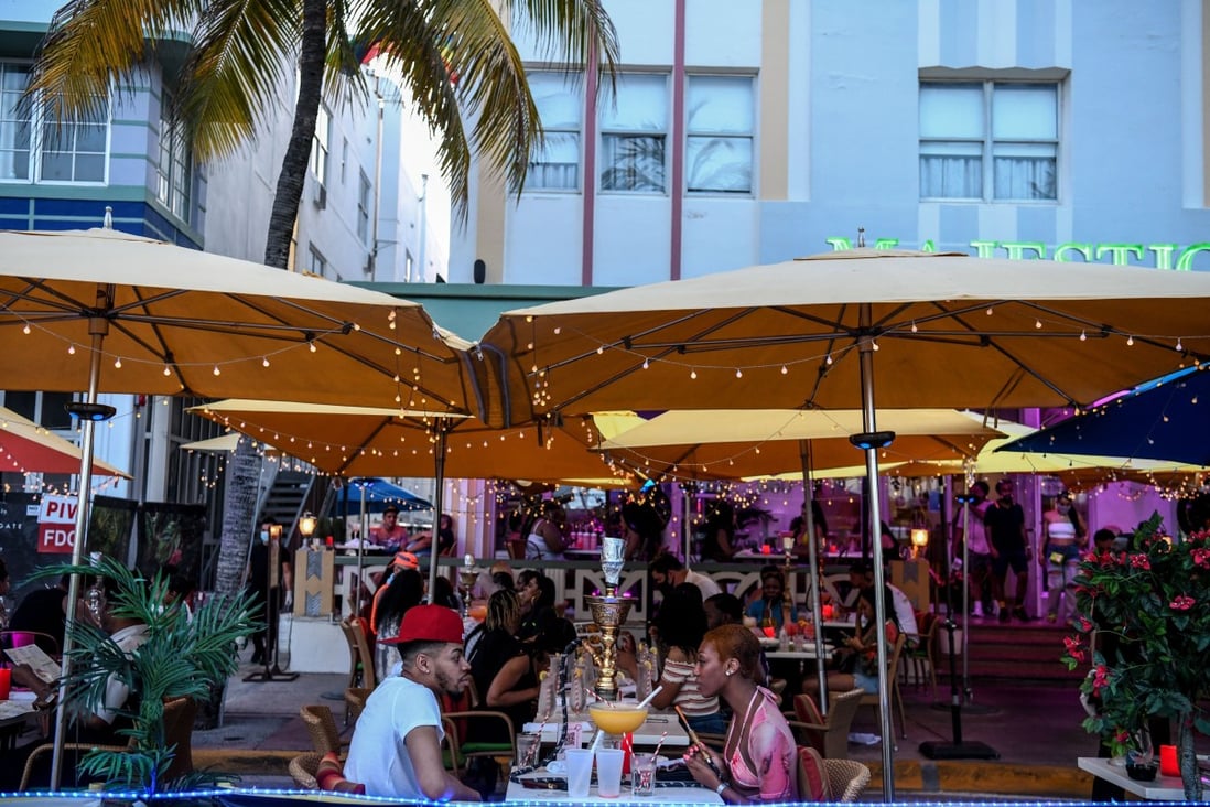 A couple enjoy drinks at a restaurant on Ocean Drive in Miami Beach, Florida, on June 26. Patrons flocked to restaurants and entertainment venues after the state eased restrictions to curb the spread of Covid-19, but Florida is now seeing a surge in case numbers. Photo: AFP