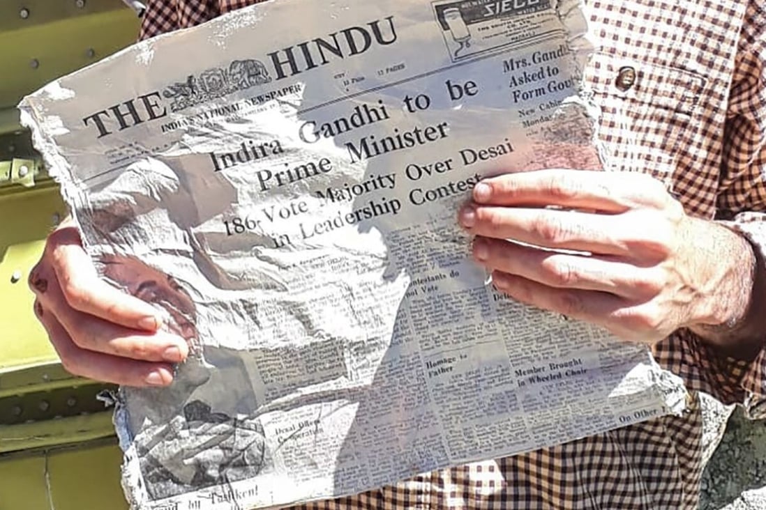 Thimotee Mottin holds a 1966 copy of Indian newspaper The Hindu, likely to have been on board the Air India aircraft that crashed. Photo: AFP