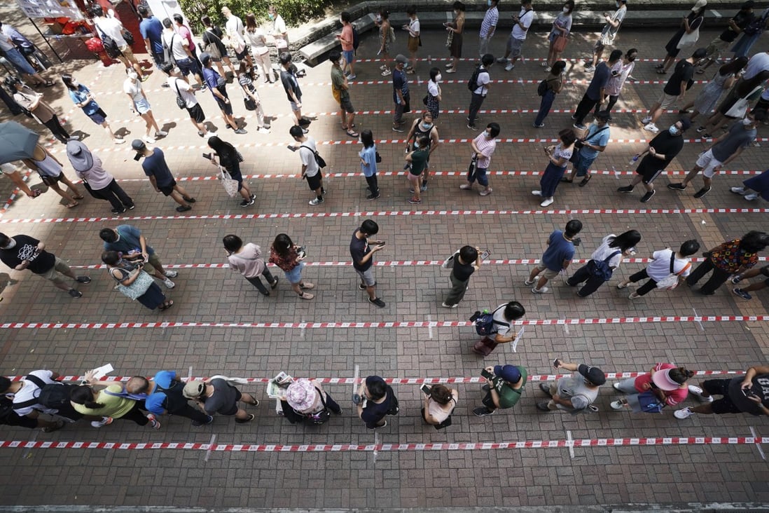 People queue up to vote at a polling station outside Tai Po Plaza in Tai Po on Sunday. Photo: Felix Wong