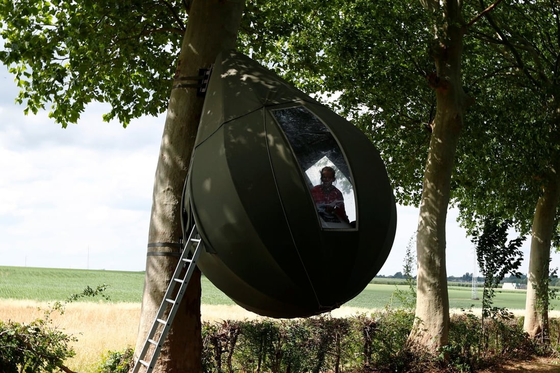 Some Belgians are staying in tents designed by Dutch artist Dre Wapenaar that hang down from trees and cost US$79 a night rather than travel abroad. Photo: Reuters