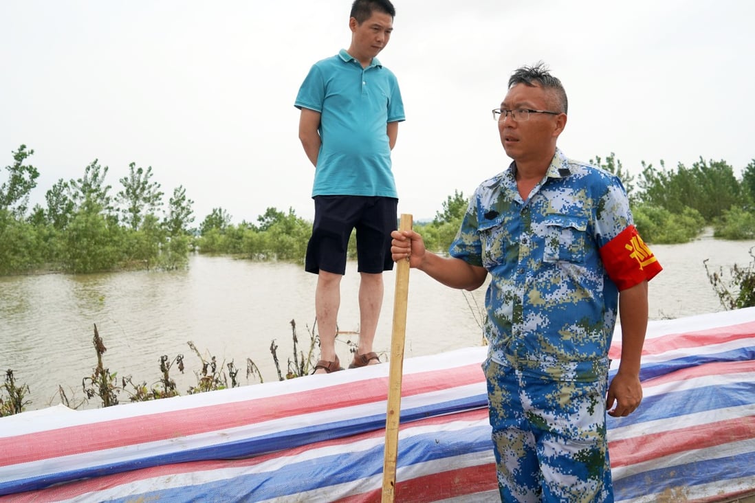 Hydraulic technician Liu Liangwu (right) remains on alert in Jiangzhou. Photo: Tom Wang