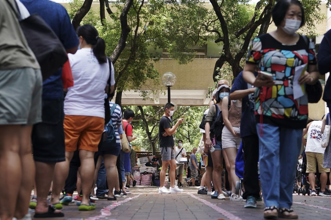 Lengthy queues form at a polling station in Tai Po on Sunday. Photo: Felix Wong