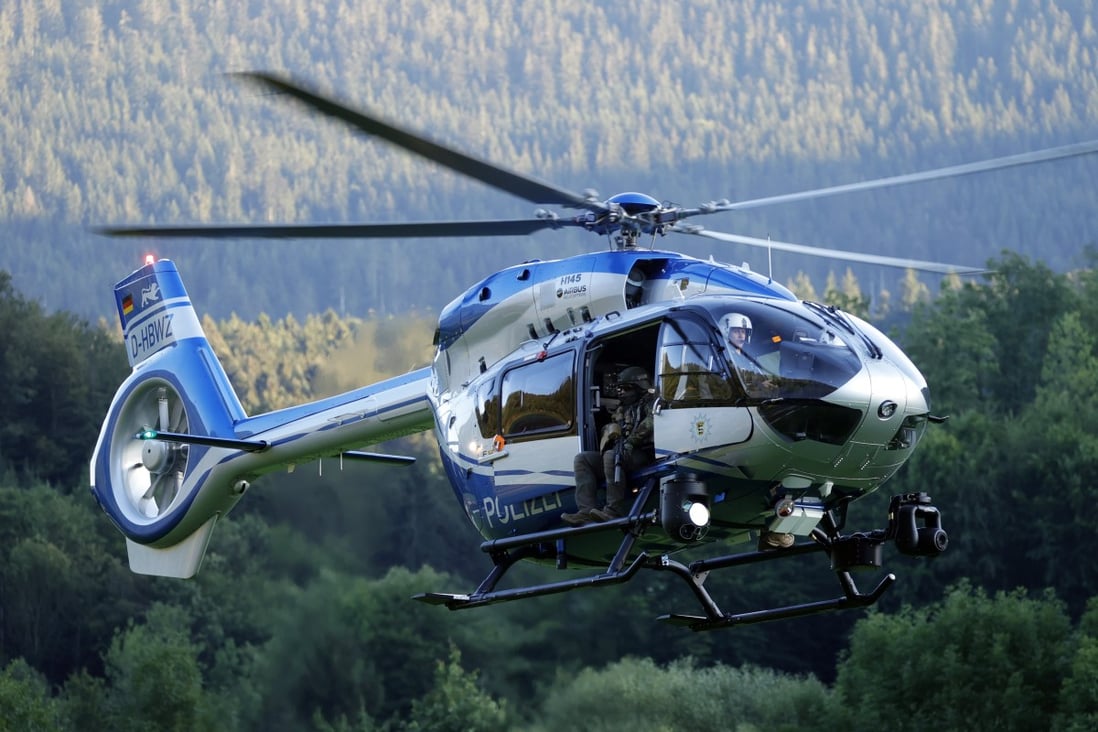 A German police helicopter combs the forest in Oppenau. Photo: EPA-EFE