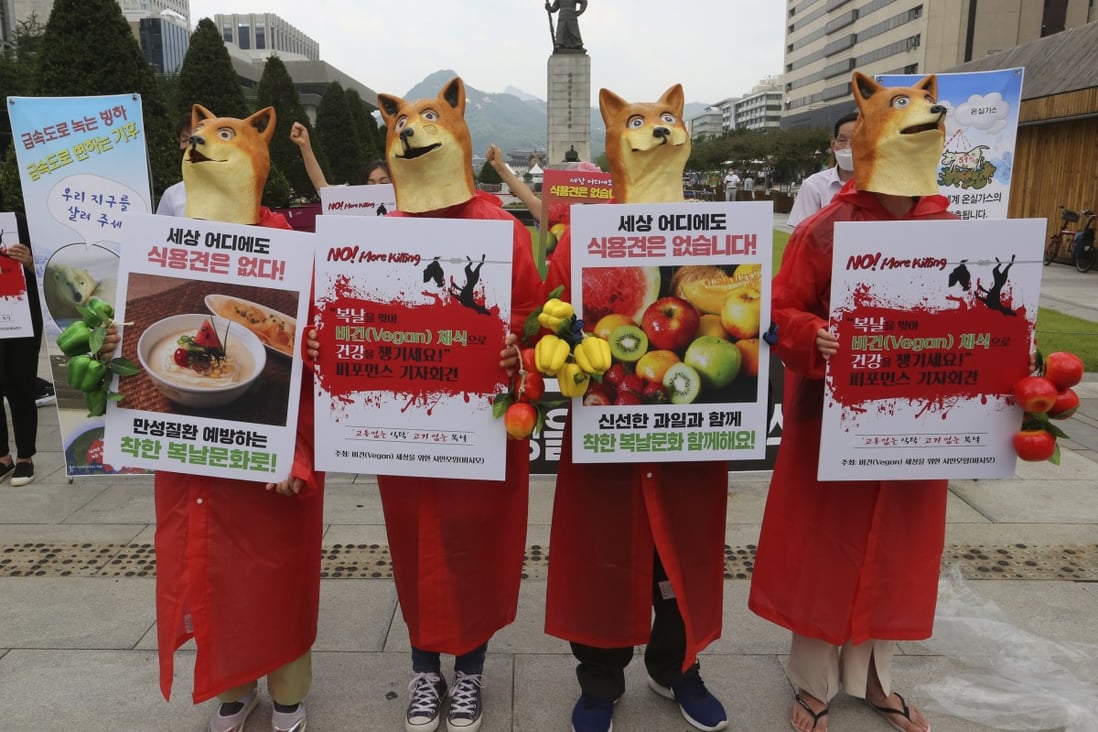 South Korean vegetarian activists wearing dog masks stage a rally opposing the country’s culture of eating dog meat. Photo: AP