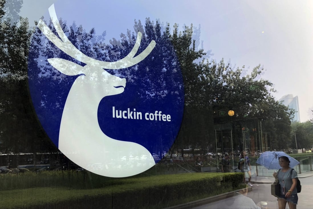 The logo of Luckin Coffee is seen on the window of a shop in Beijing. Luckin’s conceit was that it was going to have more stores in China than Starbucks – which it did – and that it was somehow going to transform coffee into a tech business, which it didn’t. Photo: Simon Song