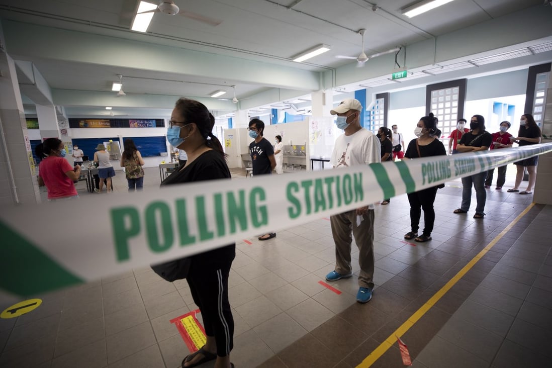 Voters queue to cast their ballots at a polling station in Singapore on July 10. Singaporeans continued the ruling People’s Action Party’s hold on power since independence but also elected a record number of opposition members to parliament as a ‘check and balance’ on the government. Photo: EPA