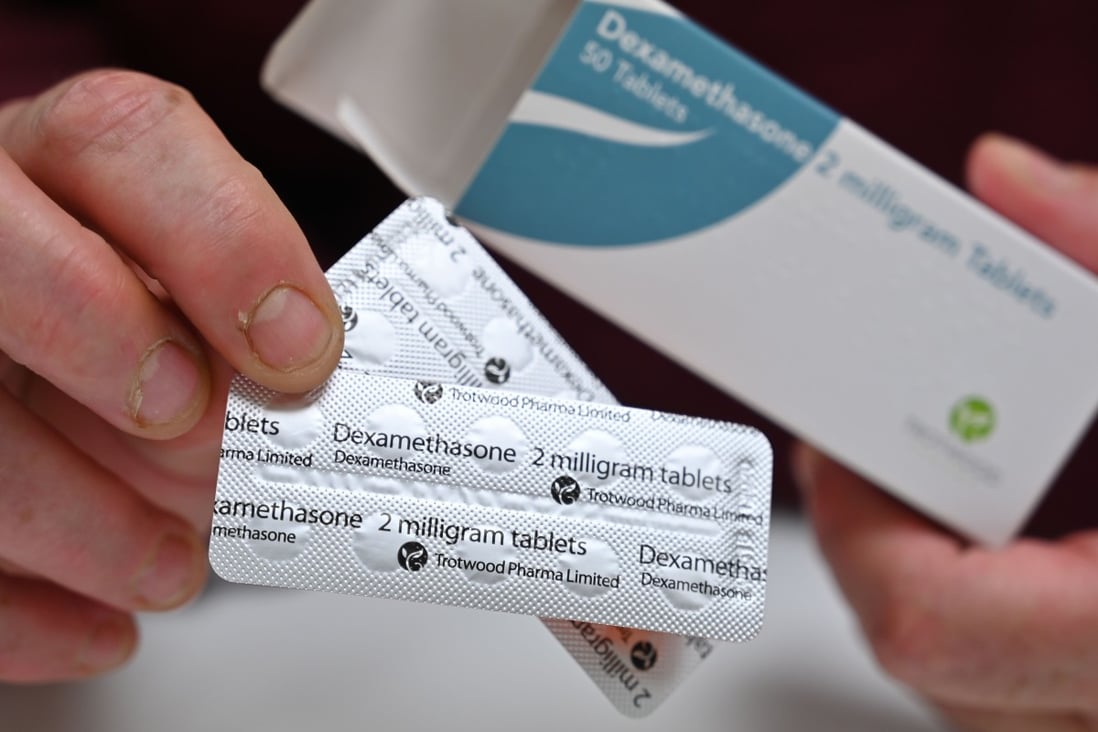 A pharmacist holds a box of dexamethasone tablets at a store in London on Thursday. Photo: AFP