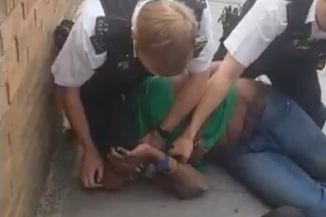 A screen grab from a video showing a London police officer apparently kneeling on a black suspect's neck. Photo: @RealAiRavish via Twitter