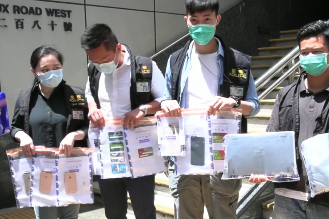 Police display seized iPhones and credit cards believed to be tied to an online scam involving air purifiers. Photo: Handout