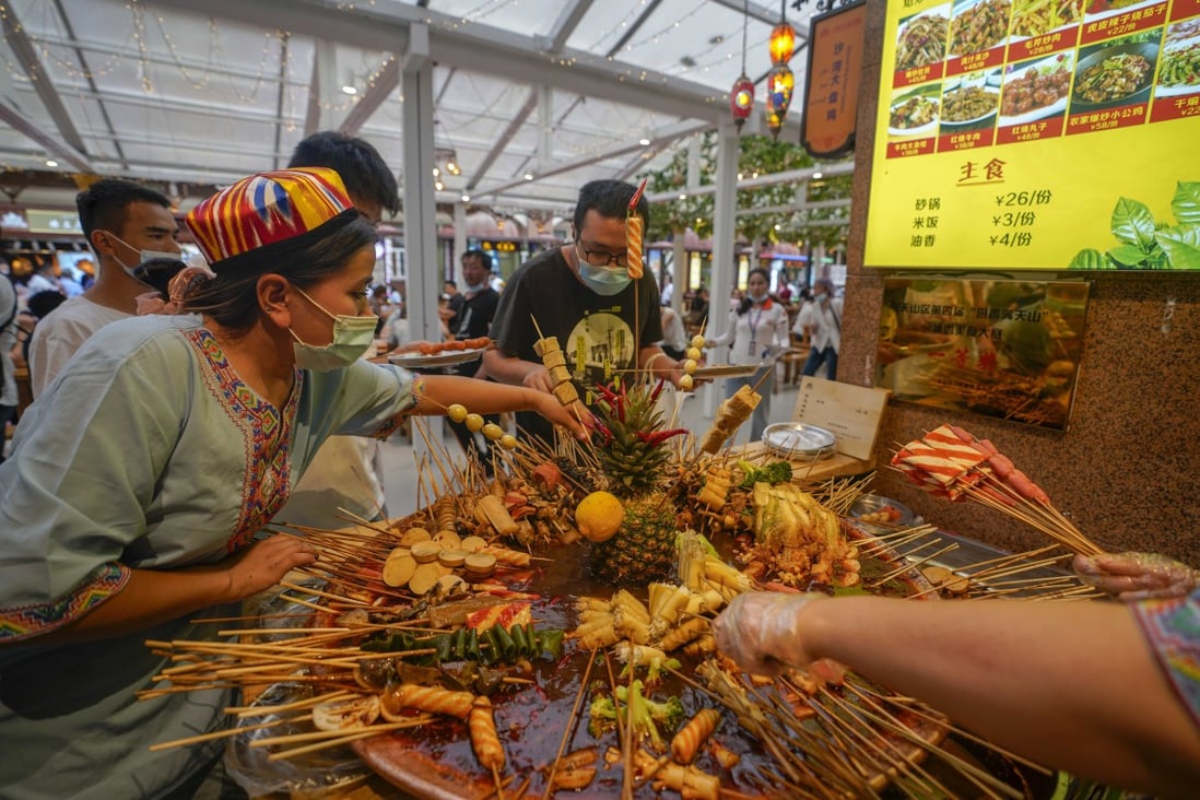 People buy snacks at the grand bazaar in Urumqi earlier this month, before the lockdown was reimposed. Photo: Xinhua