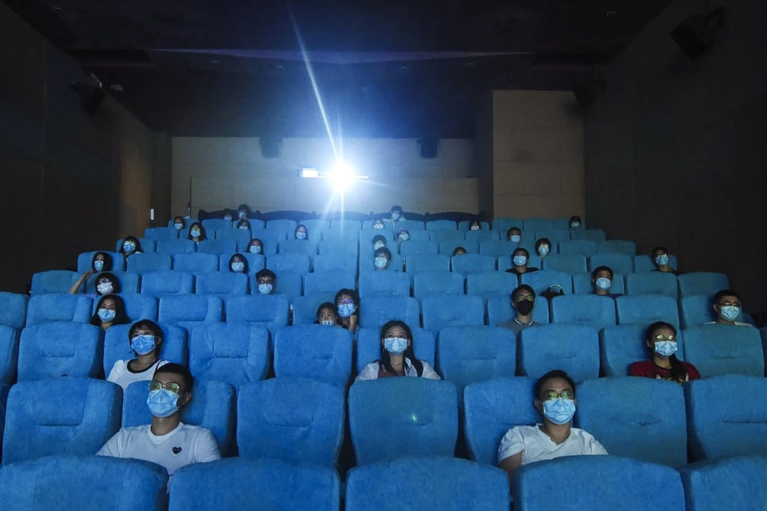 Movie-goers wearing masks sit apart as they watch a film in a newly reopened cinema in Hangzhou, eastern China. Photo: AP