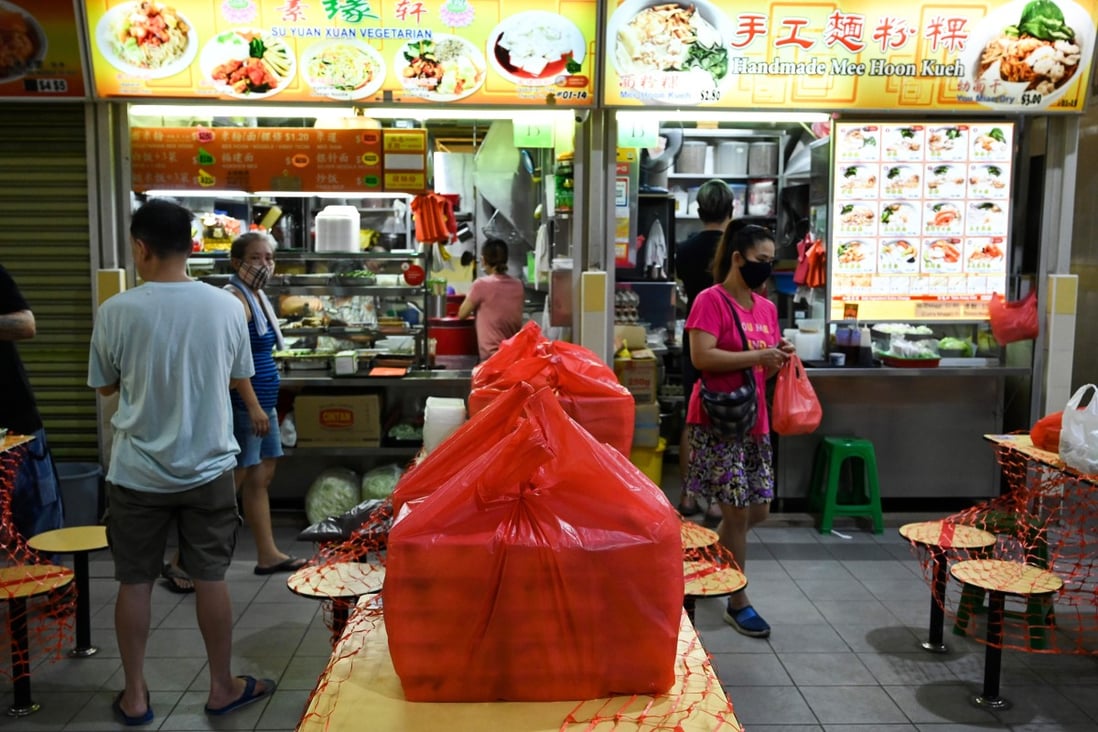 Packed lunch boxes ready for delivery are seen near a food stall in Singapore earlier this year. Photo: AFP