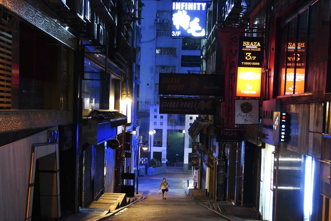 A lone person walks along a deserted street in the usually bustling nightclub area of Lan Kwai Fong in Central on Monday. Photo: Sam Tsang