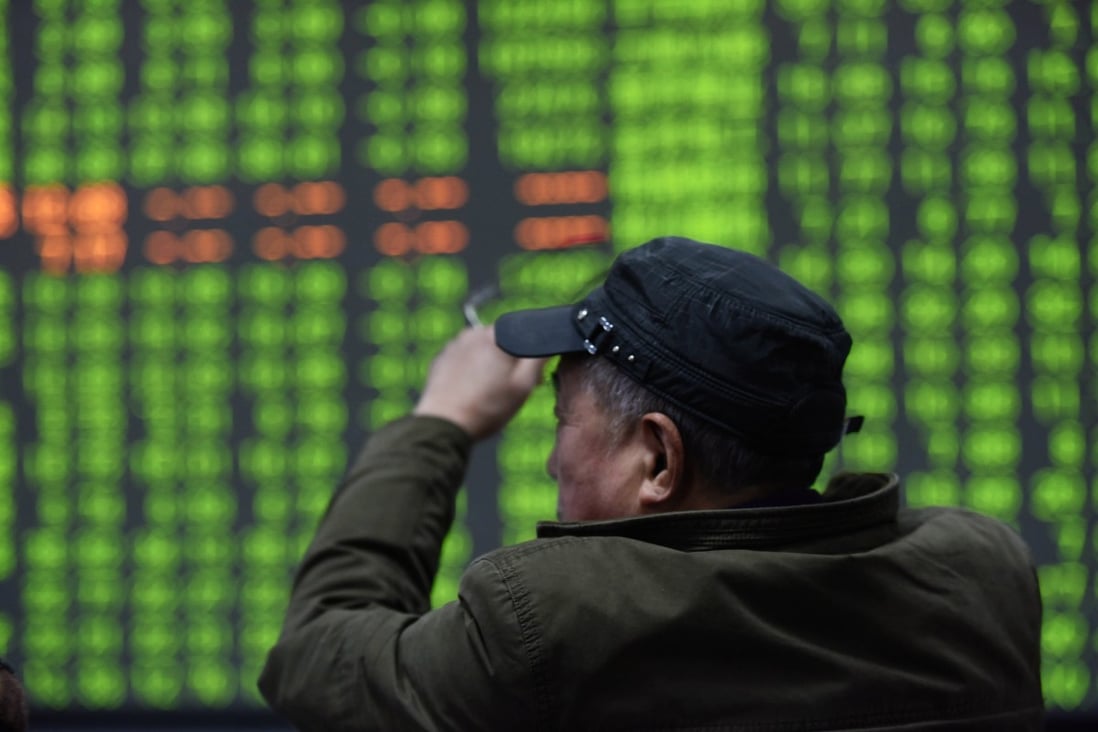Hong Kong stocks had a nasty fall, but mainland shares fell even more. Here, a stock investor looks at a stocks board in Hangzhou, Zhejiany province, China on February 3, 2020. In China, green signals losses, while red means gains. Photo: EPA-EFE/CHINA OUT