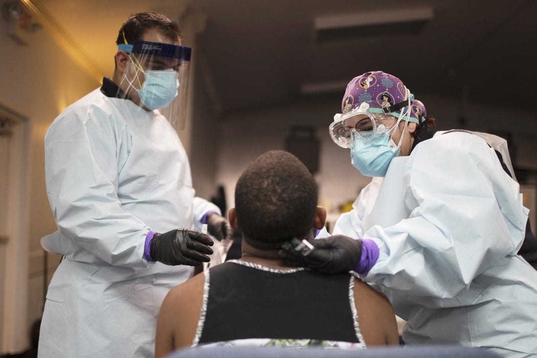 Health care workers test a person for Covid-19 at a popup testing site in Florida. Photo: Getty Images/AFP