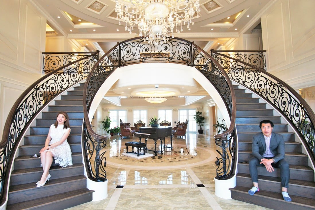 Layla Yang and Edward Zhang of Dracco Pacific Realty, on the twin staircase of 9431 No 6 Road, Richmond. Photo: Ian Young