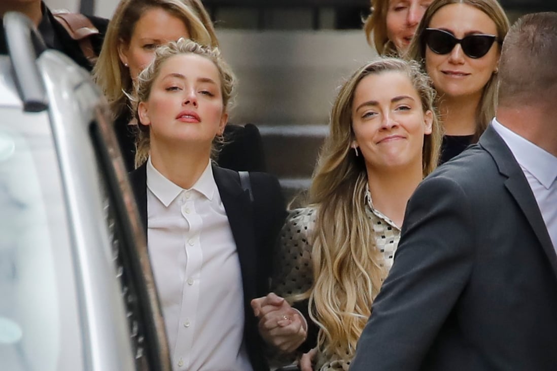 US actress Amber Heard (left) leaves hand in hand with her sister Whitney Heard from the High Court. Photo: AFP