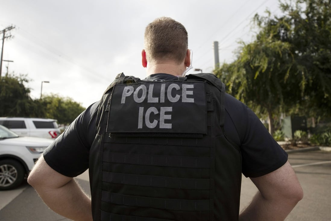 A US Immigration and Customs Enforcement (ICE) officer looks on during an operation in Escondido. Photo: AP Photo