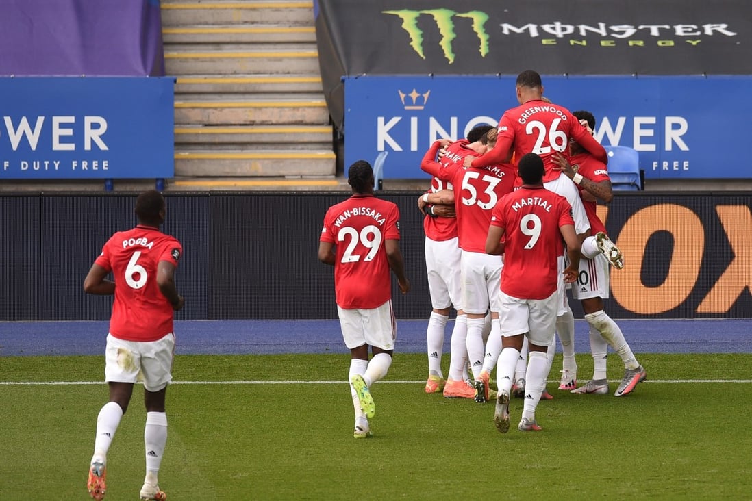 Manchester United players celebrate Bruno Fernandes’ penalty that put them in front against Leicester City. Photo: DPA