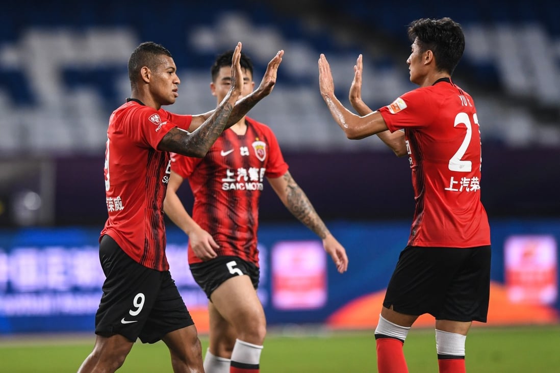 Ricardo Lopes (left) of Shanghai SIPG celebrates with his teammate Yu Hai (right) after scoring during the Chinese Super League first round match between against Tianjin Teda. Photo: Xinhua