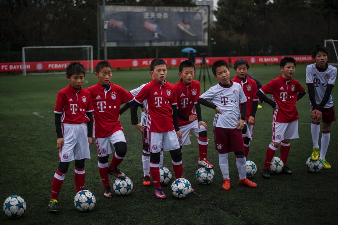 Chinese boys in Bayern Munich jerseys take part in a training session after the opening ceremony of Bayern’s Shanghai office. Photo: AFP
