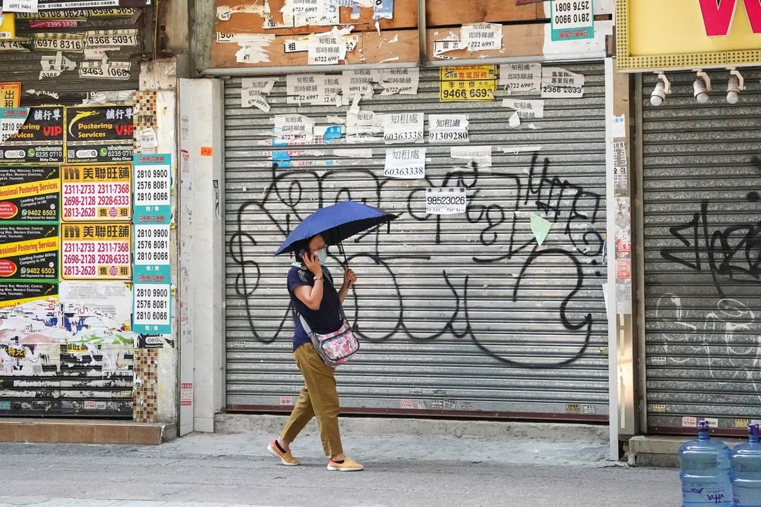 A woman walks past closed shops in Tsim Sha Tsui. Photo: Felix Wong