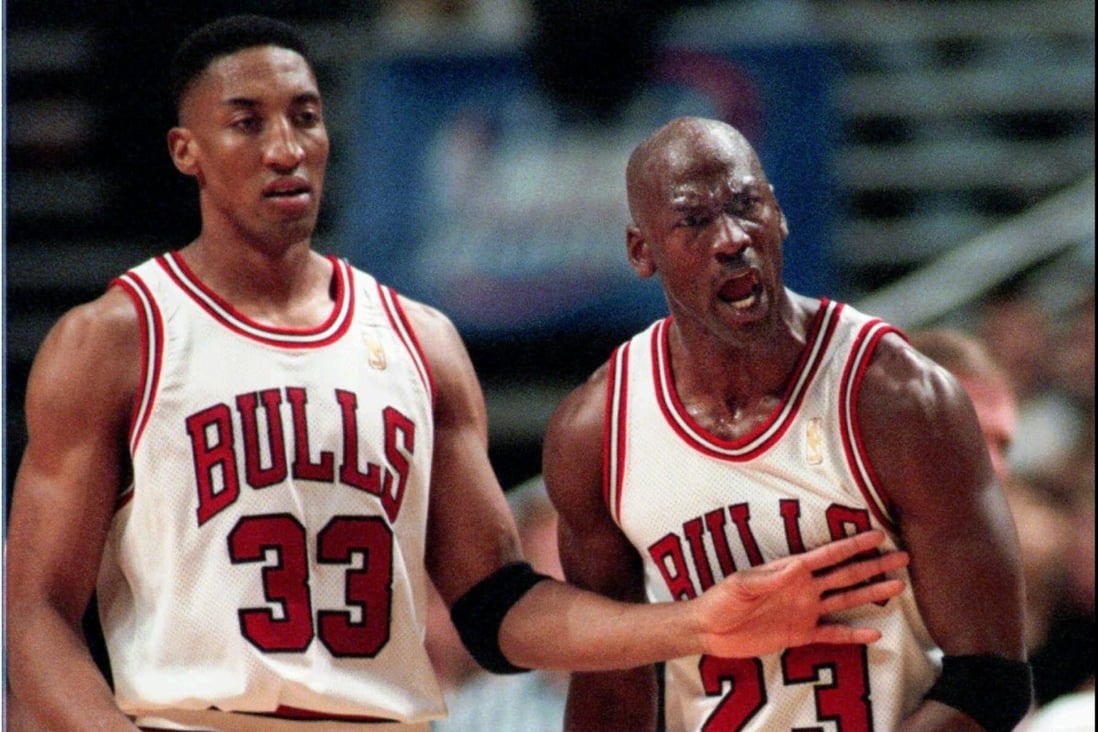 Chicago Bulls star Michael Jordan is restrained by teammate Scottie Pippen in a 1997 NBA game. Pippen has cooled talk of a rift following The Last Dance documentary. Photo: AP