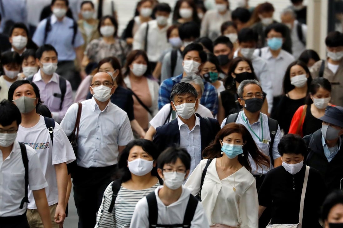 Commuters and passers-by wearing protective face masks in Tokyo. Photo: Reuters
